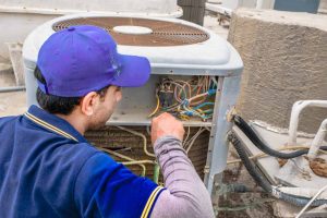 repairmen checking an AC in Zimmerman, MN