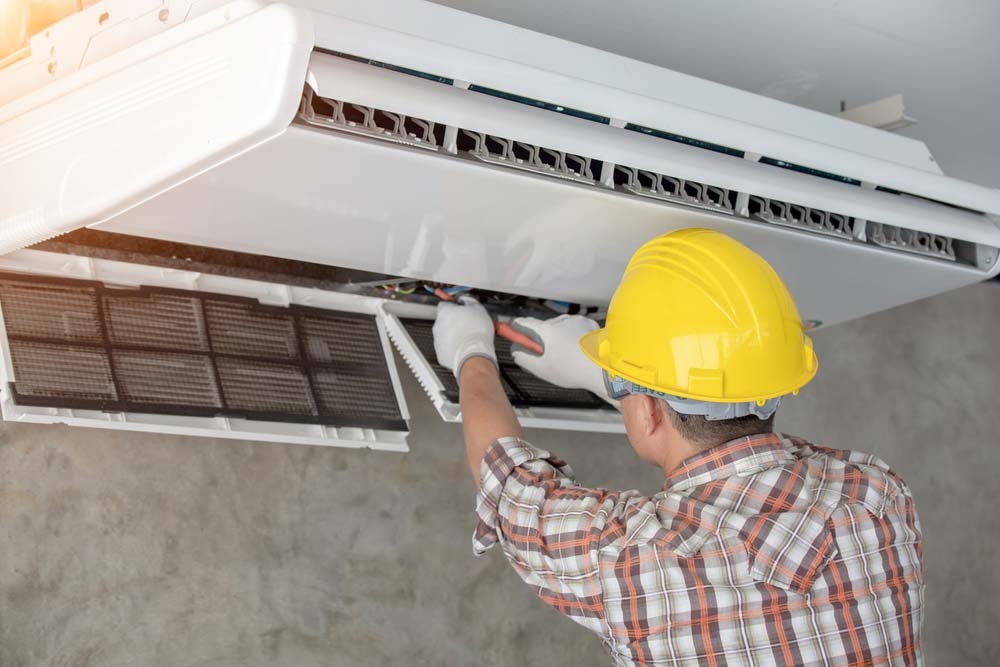 a technician doing an AC tune-up