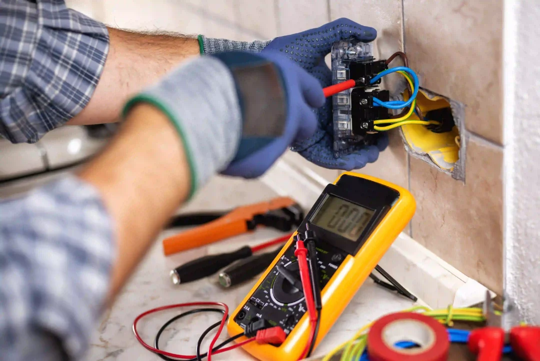 An electrician fixing an outlet